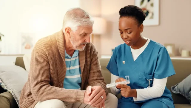 Home health nurse with elderly patient for medication management