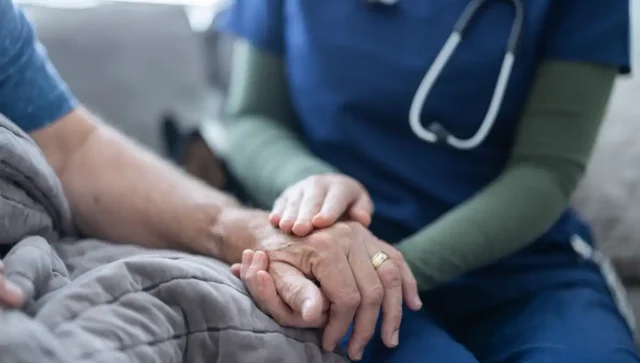 palliative nurse with patient at home.