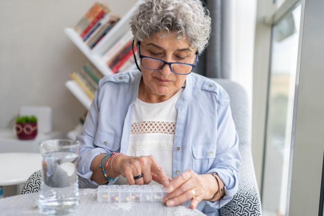 A woman taking her daily medications