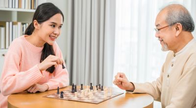 Hospice volunteer playing chess with a hospice patient