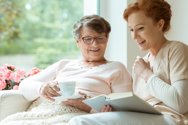 Hospice volunteer reading with a hospice patient