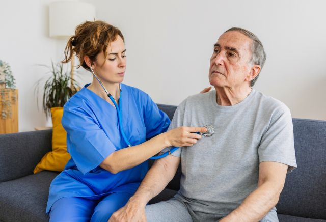 A photo of a patient with Alzheimer's with a hospice nurse