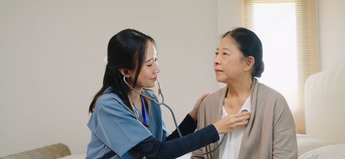 Hospice nurse listening to patients heart