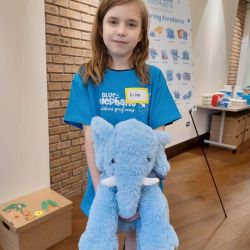 Child-with-blue-elephant Small girl at children's grief camp.