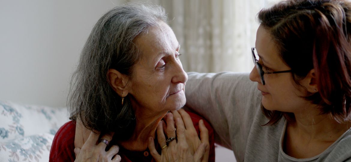 Woman hugging her elderly mother